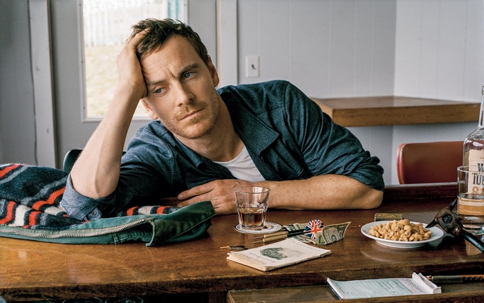 Michael Fassbender sitting at a bar