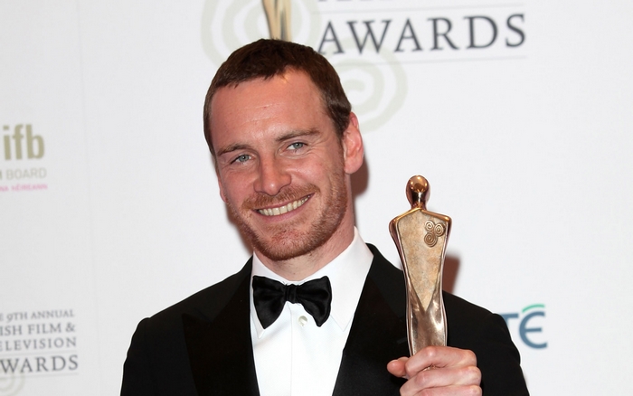 Michael Fassbender holding an award