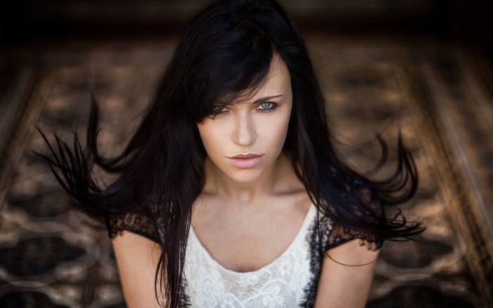 Woman with dark hair and blue eyes