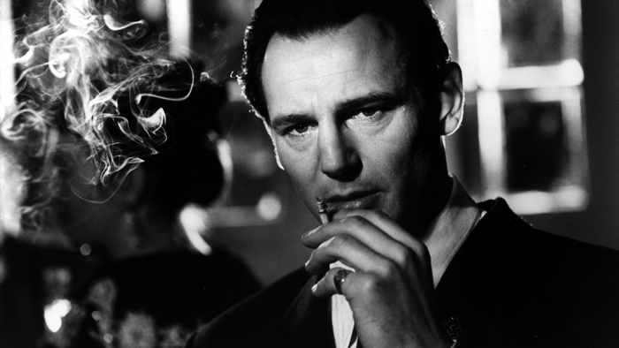 Liam Neeson smoking a cigarette