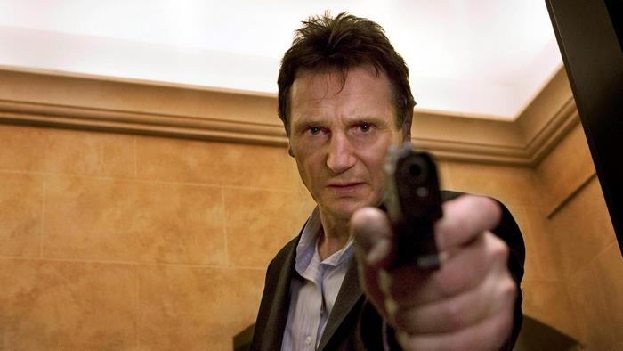 Liam Neeson holding a gun