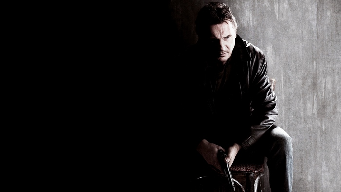 Liam Neeson holding a gun