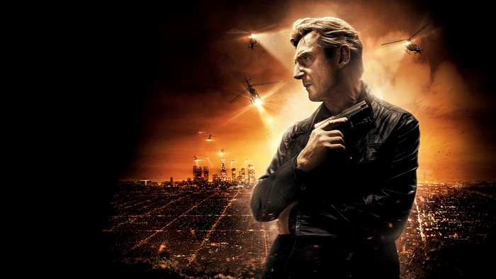 Liam Neeson holding a gun over a city at night