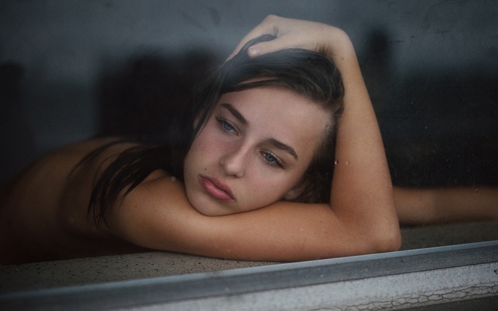 Young woman resting her head on her arms