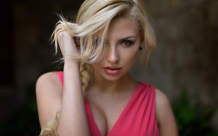 Woman with blonde hair in pink dress