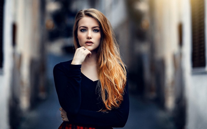 Woman with red hair in black shirt