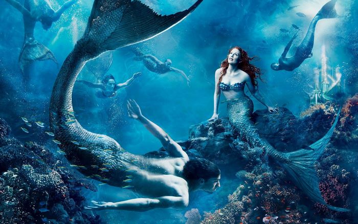 Mermaids swimming near coral reef and underwater castle