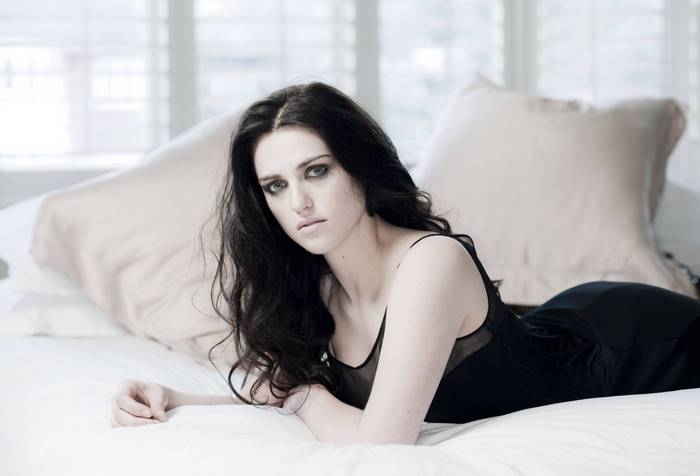 Katie McGrath lying on a bed