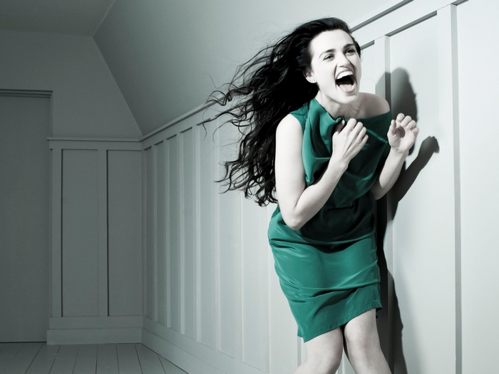 Katie McGrath screaming in a green dress