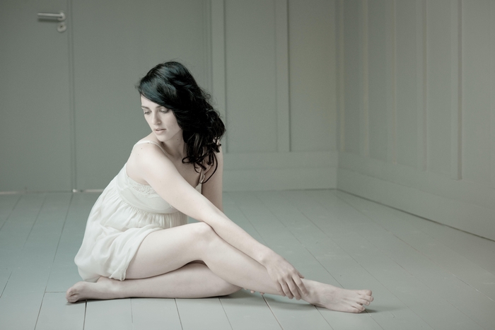 Katie McGrath sitting on floor