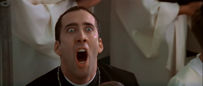 Nicolas Cage in a priest outfit