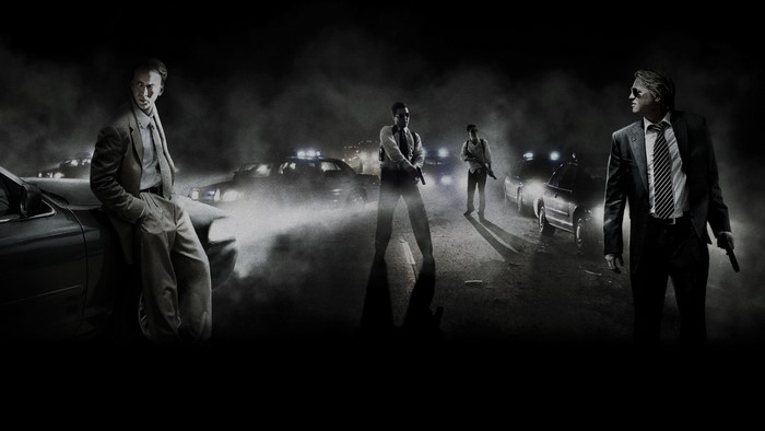 Nicolas Cage and other men with guns on a foggy road