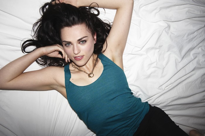 Katie McGrath lying on a white sheet