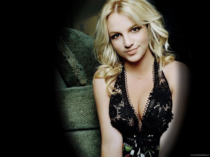 Britney Spears in Black Lace Dress Sitting on Couch