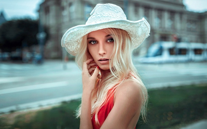 Woman in a white hat and red dress