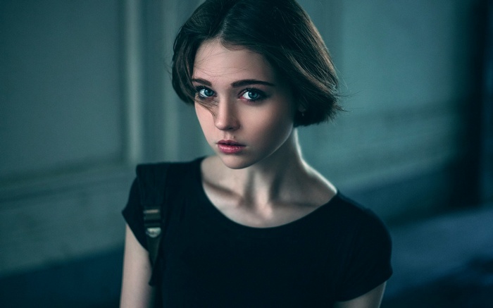 Young woman with short dark hair and blue eyes