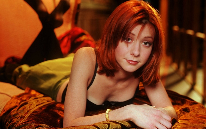 Alyson Hannigan lying on a bed