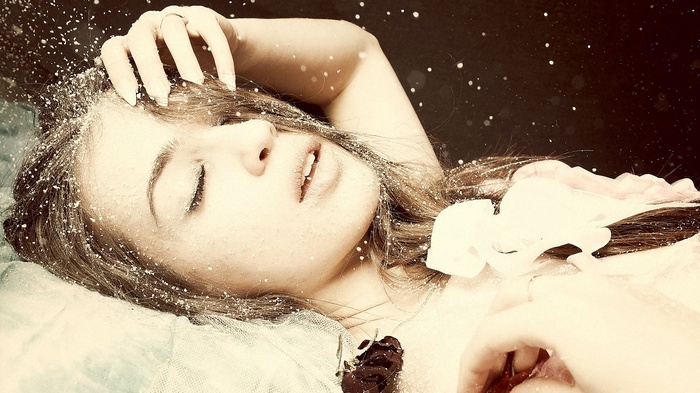 Woman lying down with snow on her face