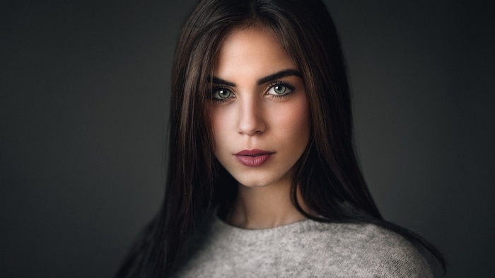Woman with dark hair and green eyes