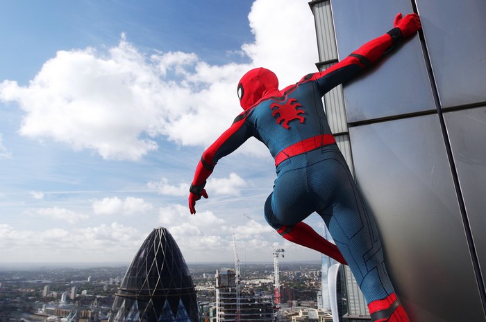 Tom Holland as Spider-Man climbing a skyscraper