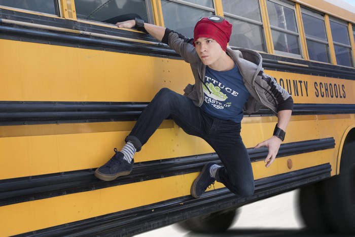 Tom Holland as Spider-Man on a school bus