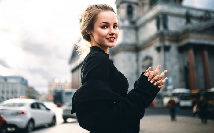 Woman in black jacket on city street