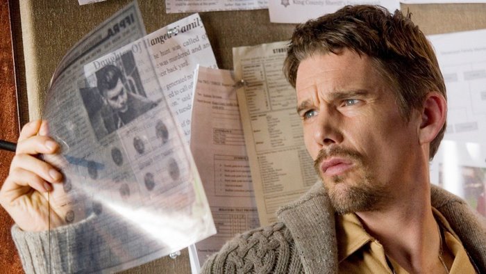 Ethan Hawke examines newspaper clippings