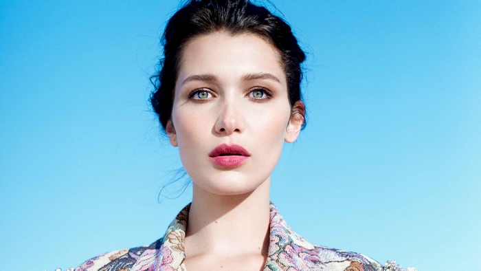 Bella Hadid in patterned jacket against blue sky