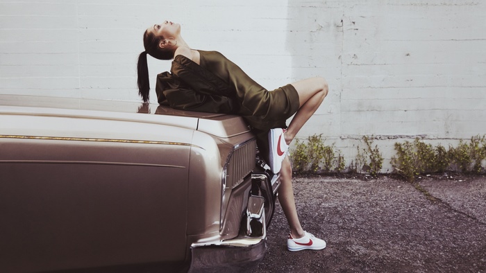 Bella Hadid posing on a vintage car
