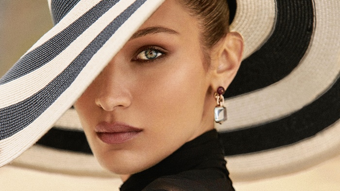 Bella Hadid wearing a striped hat and earring