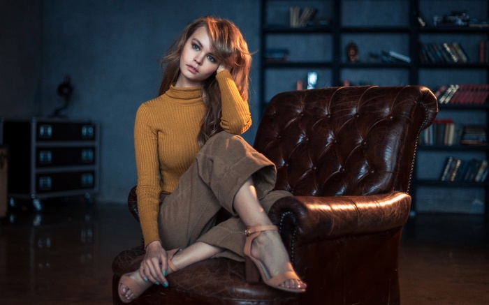 Woman sitting in a leather chair