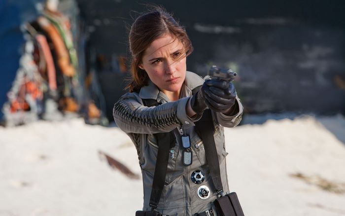 Rose Byrne aiming a gun