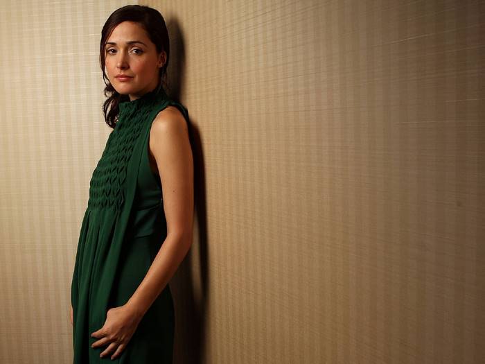 Rose Byrne leaning against a wall