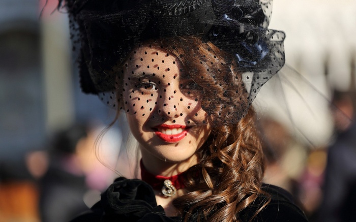 Woman in a black hat and veil