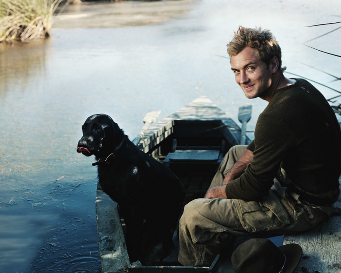 Jude Law and dog in a boat