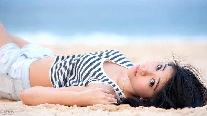 Woman lying on a beach