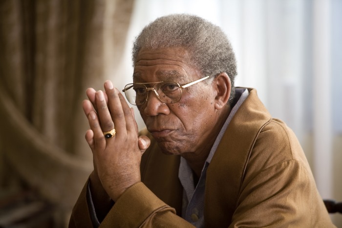 Morgan Freeman wearing glasses and a brown robe