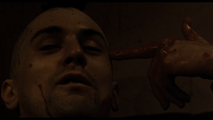 Robert De Niro with bloody hand to head