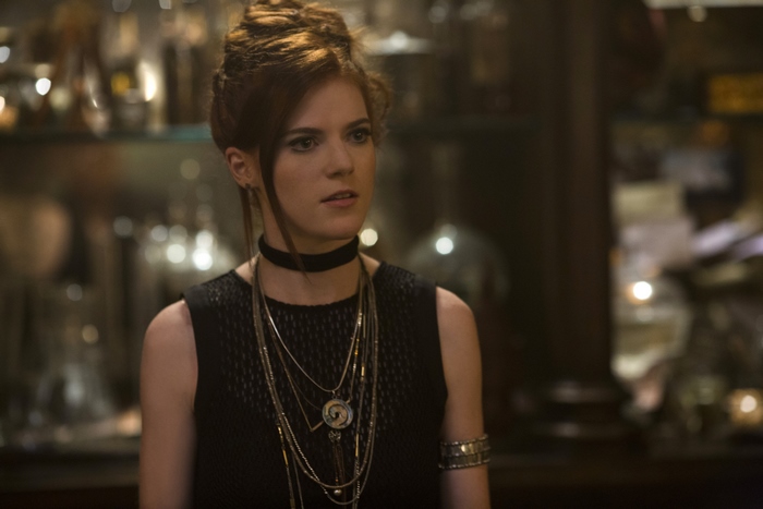 Rose Leslie in a black dress with necklaces