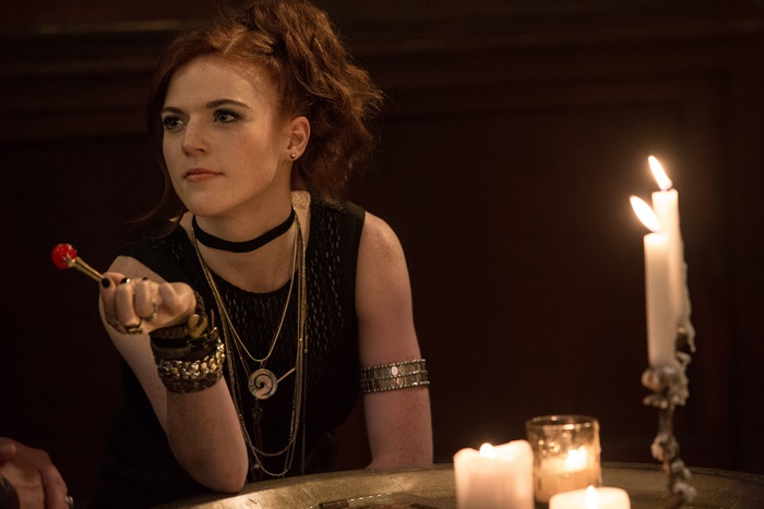 Rose Leslie holding a dart