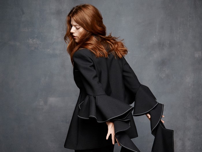 Rose Leslie in black jacket with bell sleeves