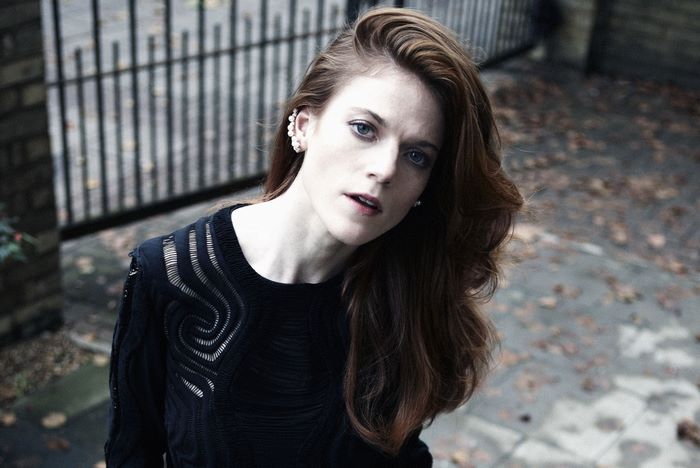 Rose Leslie wearing a black sweater