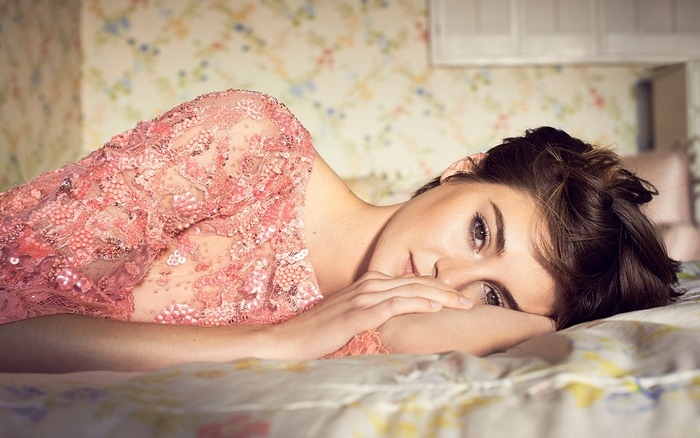 Shailene Woodley lying on a bed