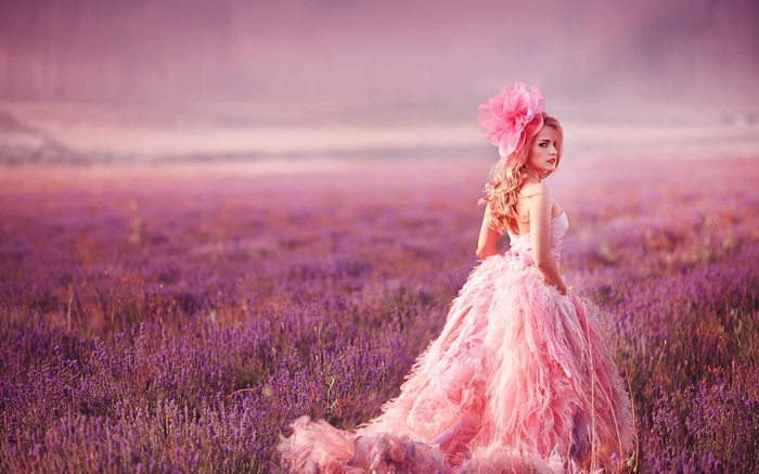 Woman in pink dress in lavender field