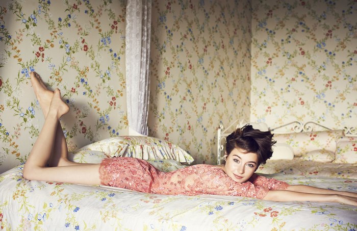 Shailene Woodley lying on a bed