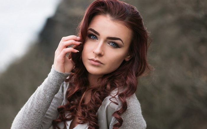 Woman with auburn hair and blue eyes