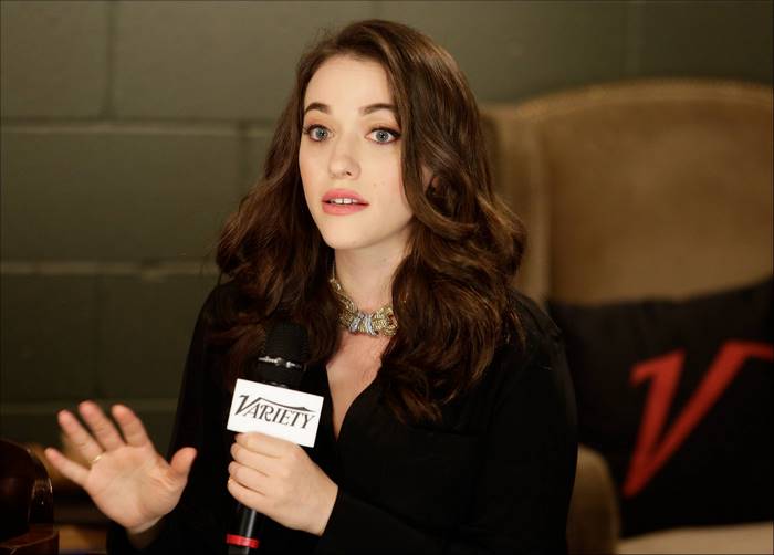Kat Dennings holding a Variety microphone
