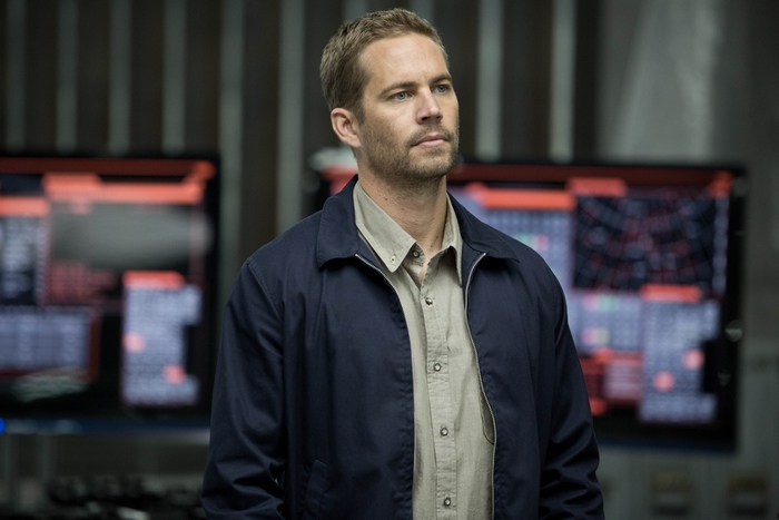 Paul Walker in a dark room with monitors