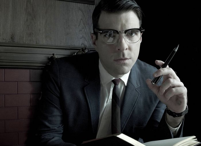 Zachary Quinto wearing glasses and suit