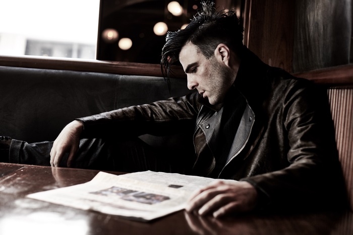 Zachary Quinto reading a newspaper